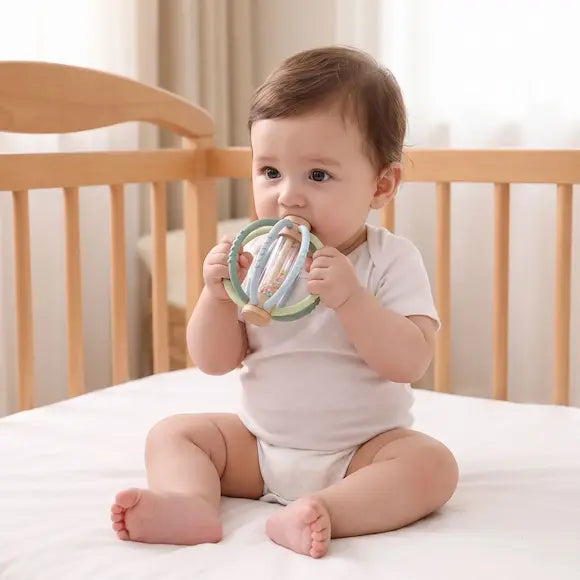 bébé assis berceau tient hochet pour bebe bouche