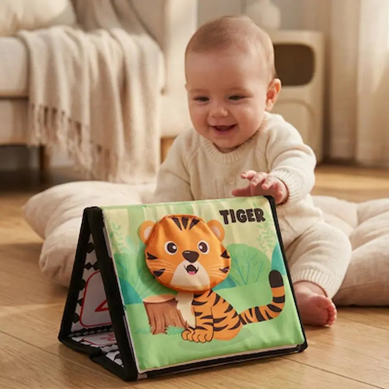 bebe assis coussin leve main prend livre bebe en tissus