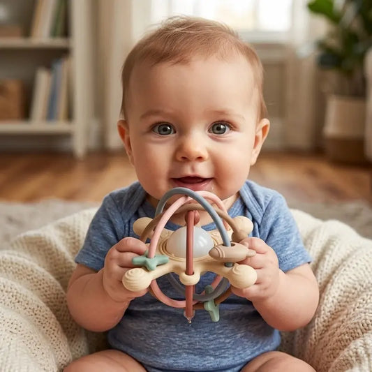 bébé assis tient mains hochet bébé planète