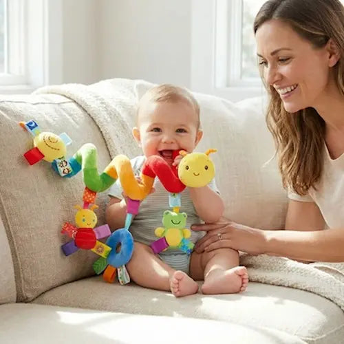 bébé joyeux assis canapé mordille hochet pour bebe maman surveille