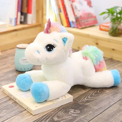 licorne peluche bleue arc en ciel sur parquet