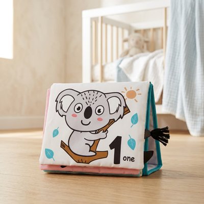 livre bebe en tissus koala posé parquet chambre